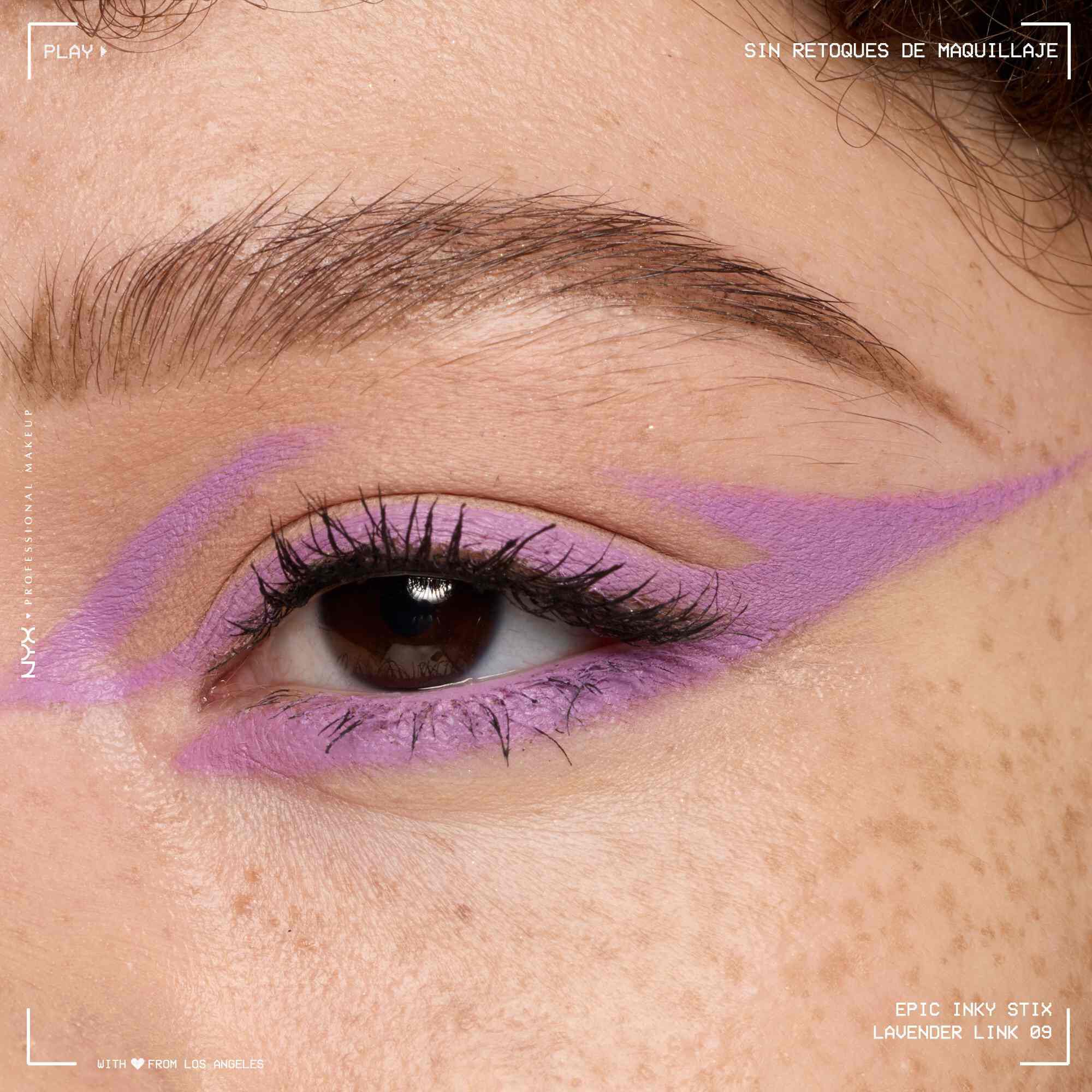 Close of a model wearing Epic Inky Stix on the top of their eyelid as a winged liner style in shade 08 Lavender Link