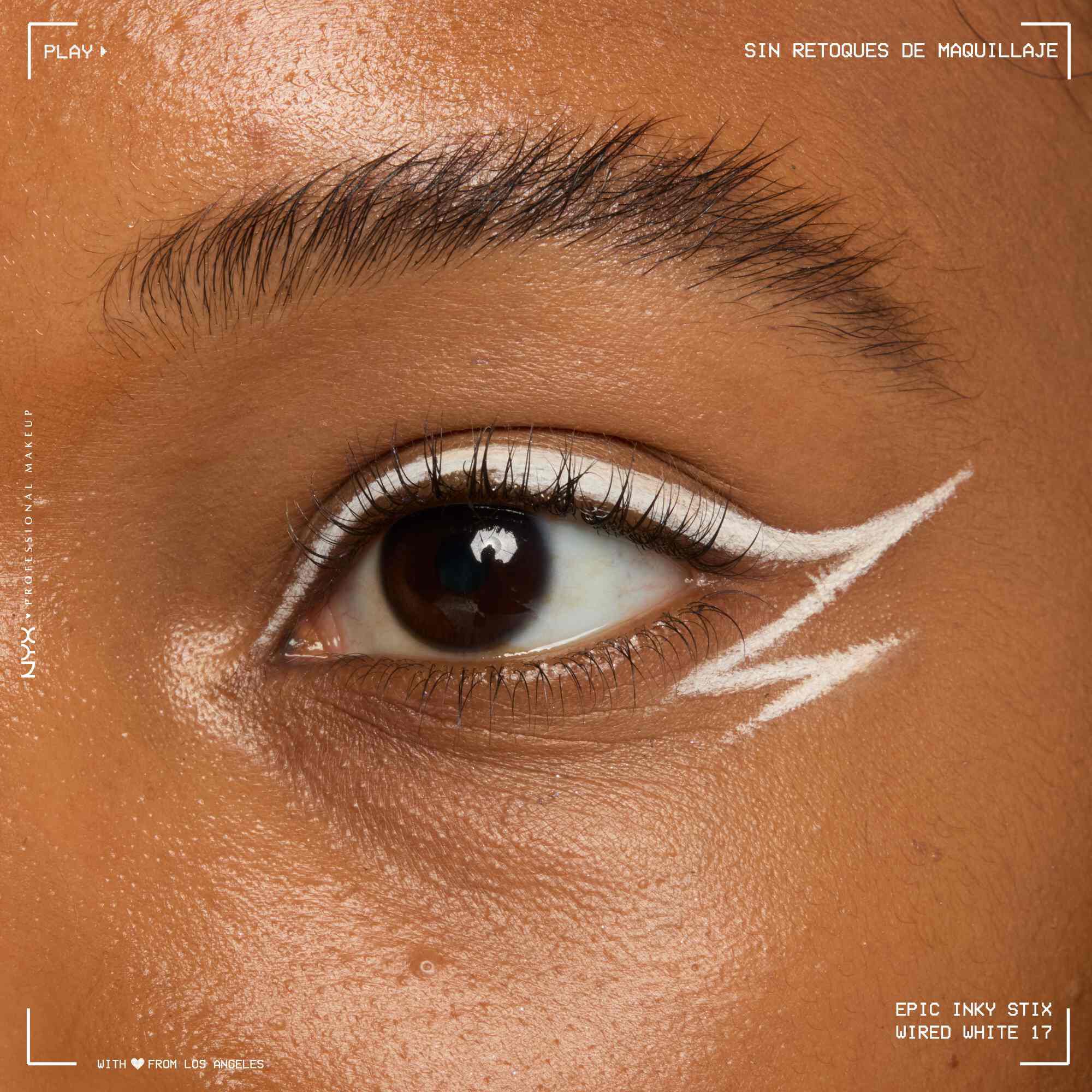 Close of a model wearing Epic Inky Stix on the top of their eyelid as a winged liner style in shade 17 Wired White