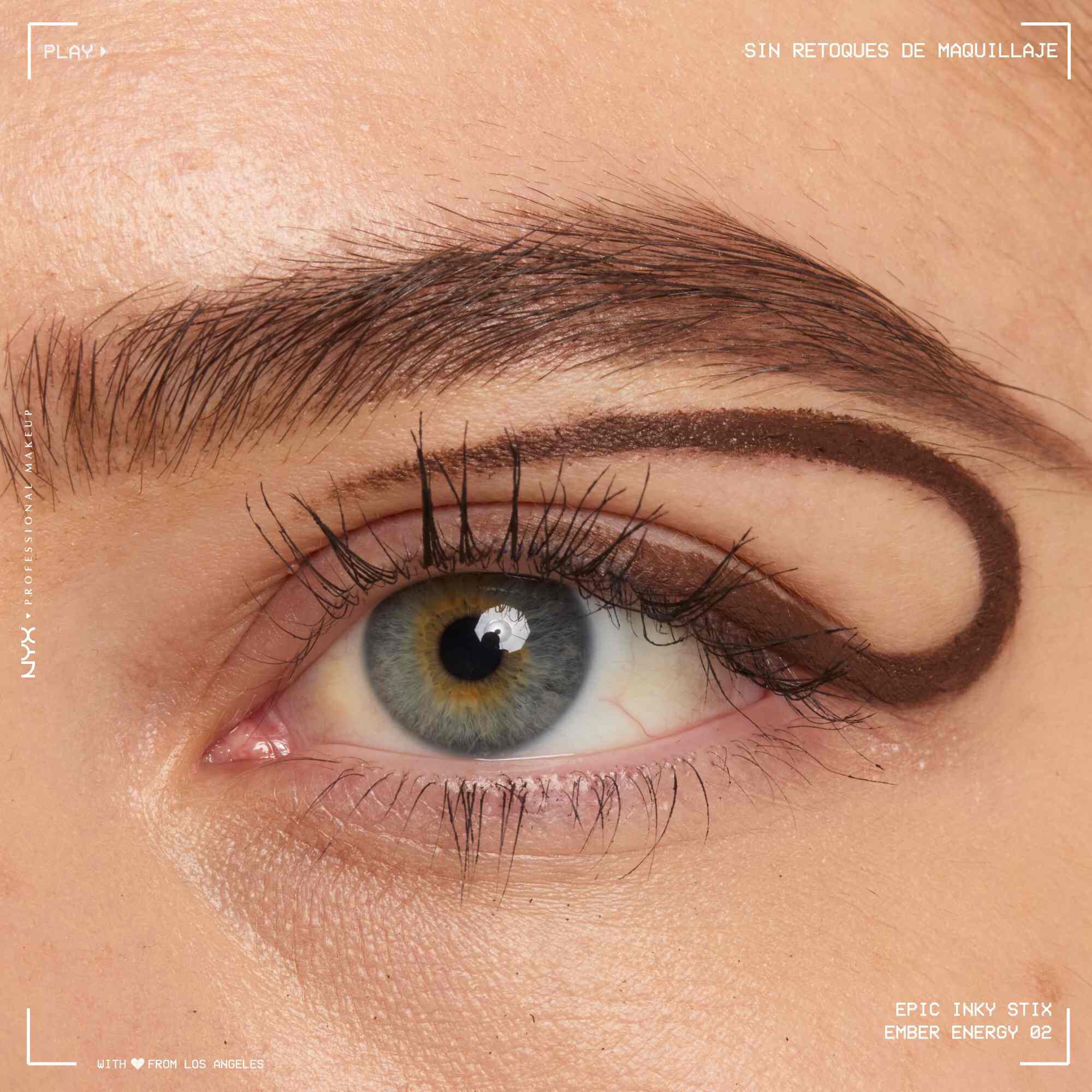Close of a model wearing Epic Inky Stix on the top of their eyelid as a winged liner style in shade 02 Ember Energy