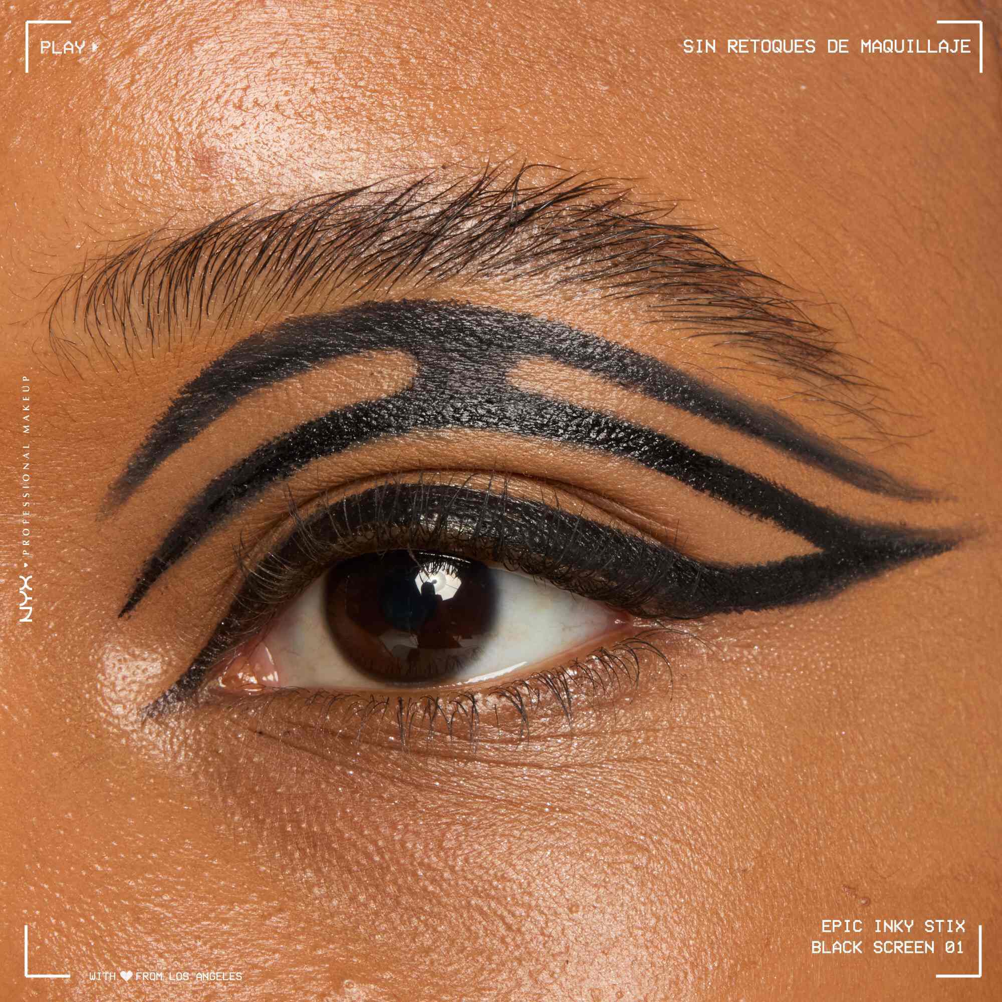 Close of a model wearing Epic Inky Stix on the top of their eyelid as a winged liner style in shade 01 Black Screen