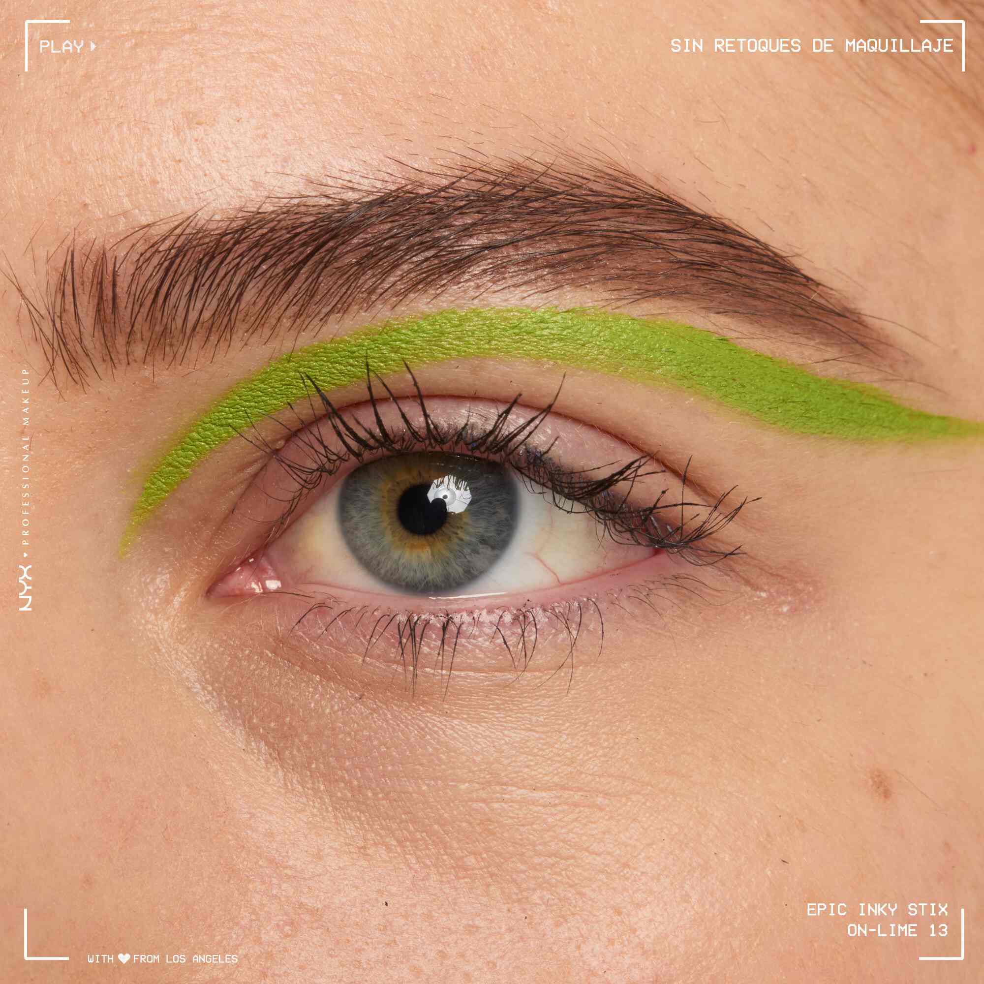 Close of a model wearing Epic Inky Stix on the top of their eyelid as a winged liner style in shade 13 On-Lime