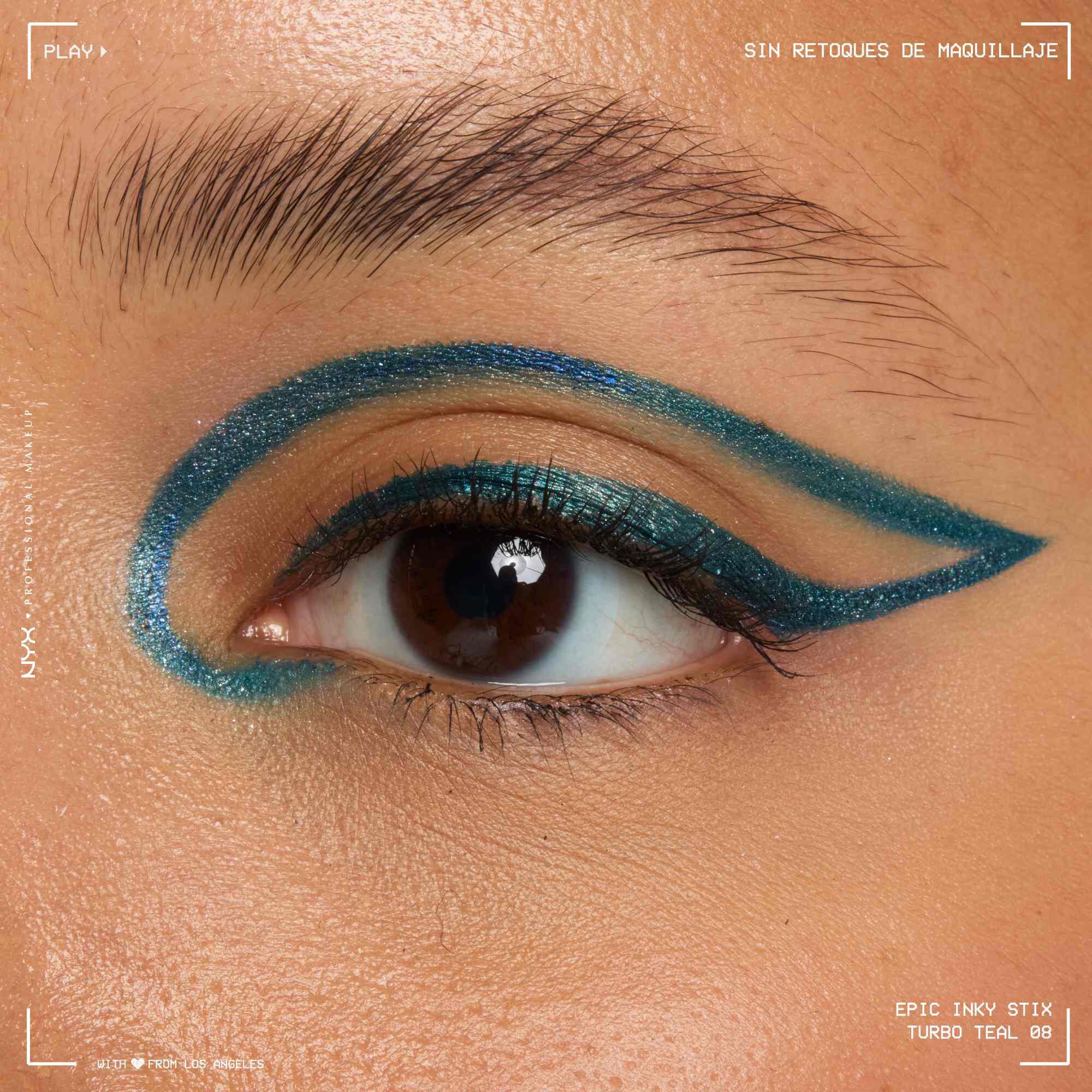 Close of a model wearing Epic Inky Stix on the top of their eyelid as a winged liner style in shade 07 Turbo Teal