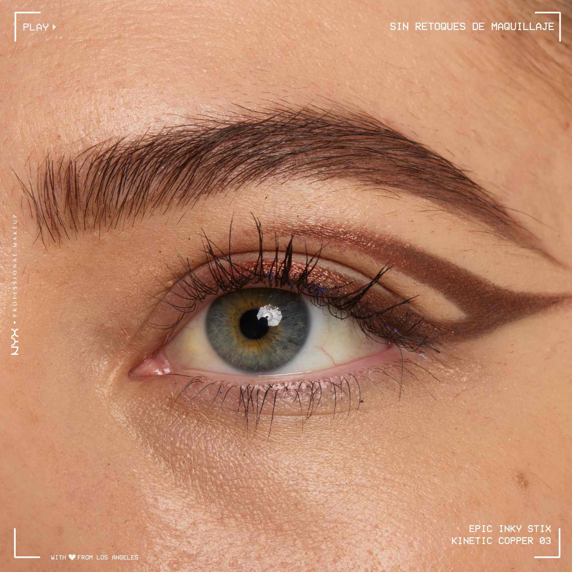 Close of a model wearing Epic Inky Stix on the top of their eyelid as a winged liner style in shade 03 Kinetic Copper