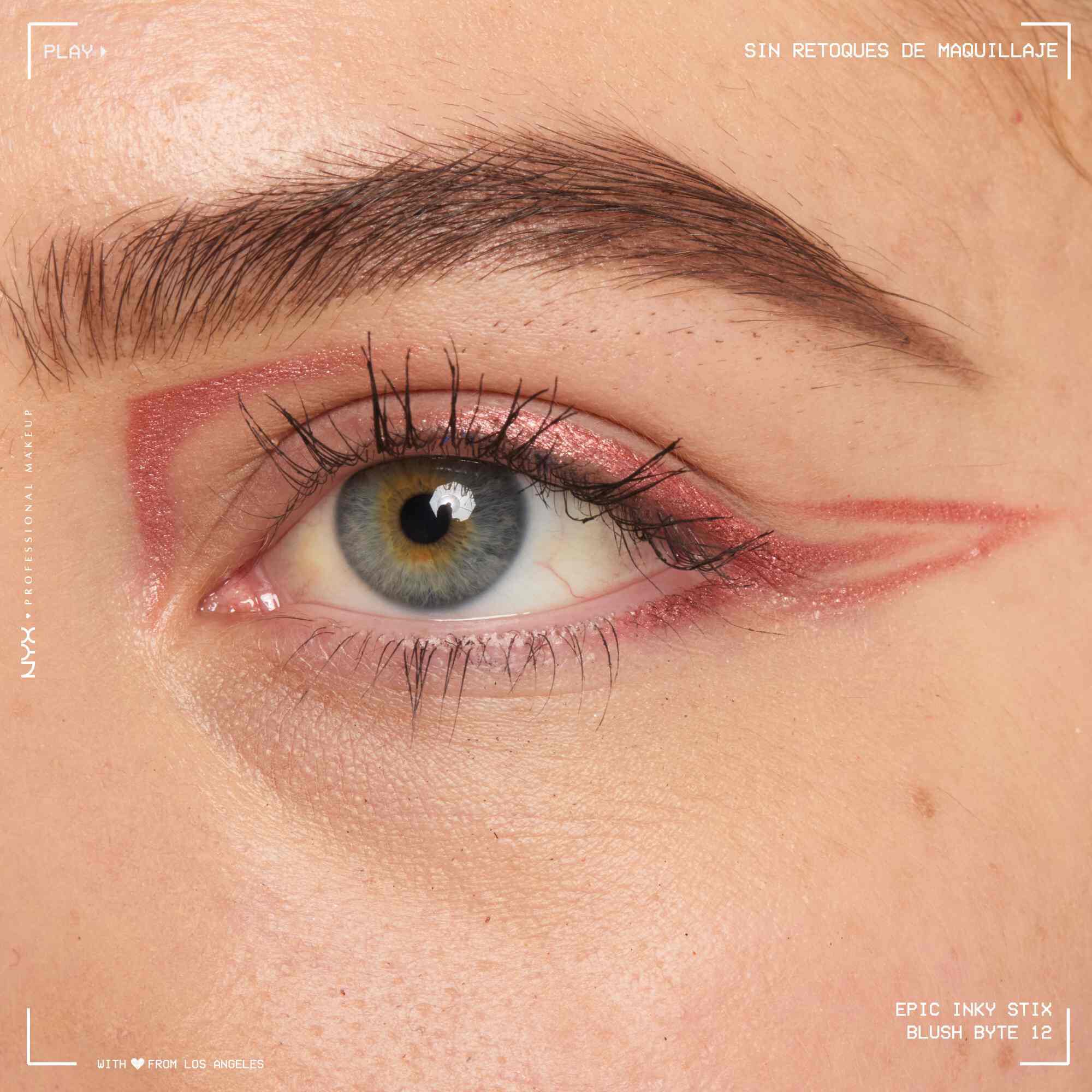 Close of a model wearing Epic Inky Stix on the top of their eyelid as a winged liner style in shade 12 Blush Byte