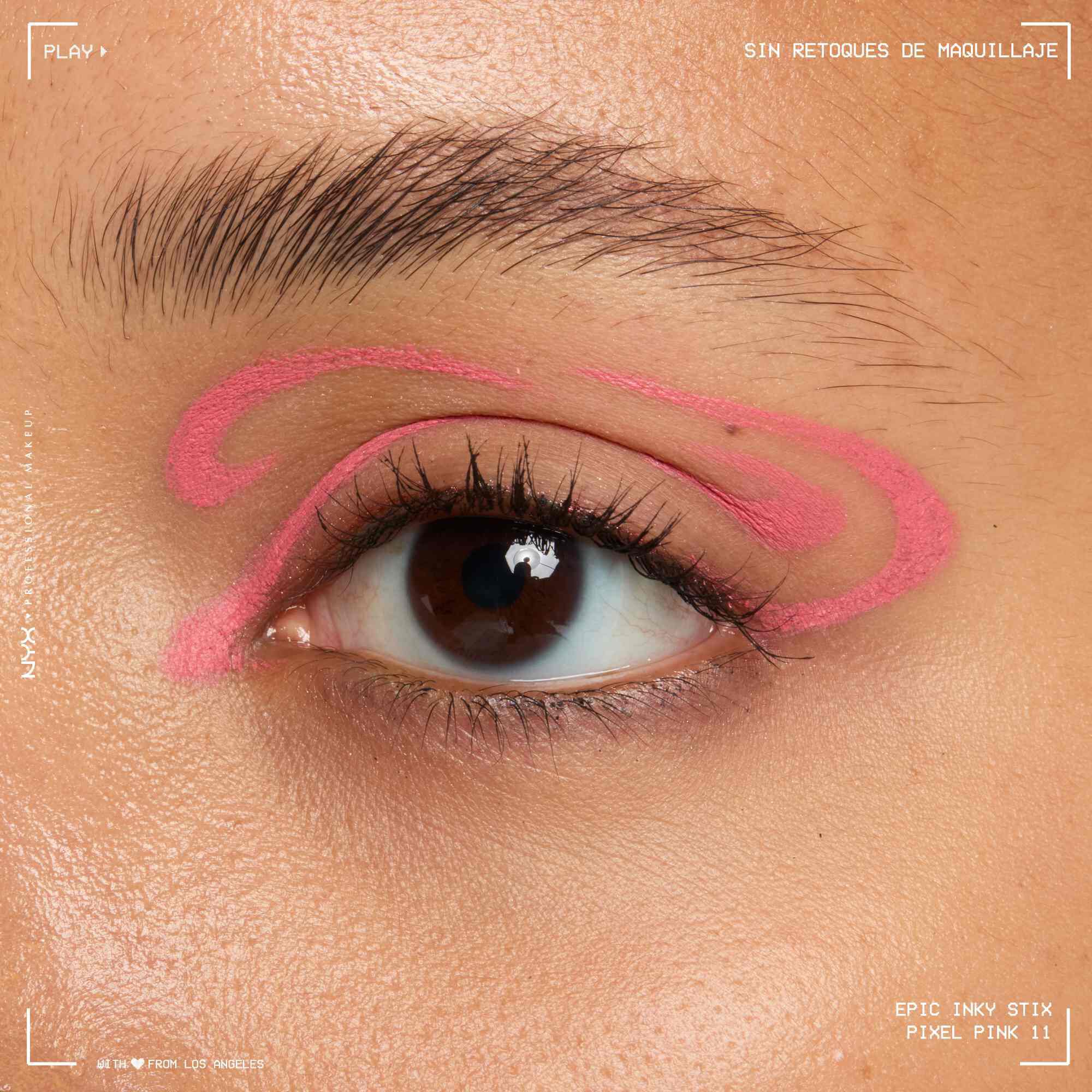 Close of a model wearing Epic Inky Stix on the top of their eyelid as a winged liner style in shade 11 Pixel Pink
