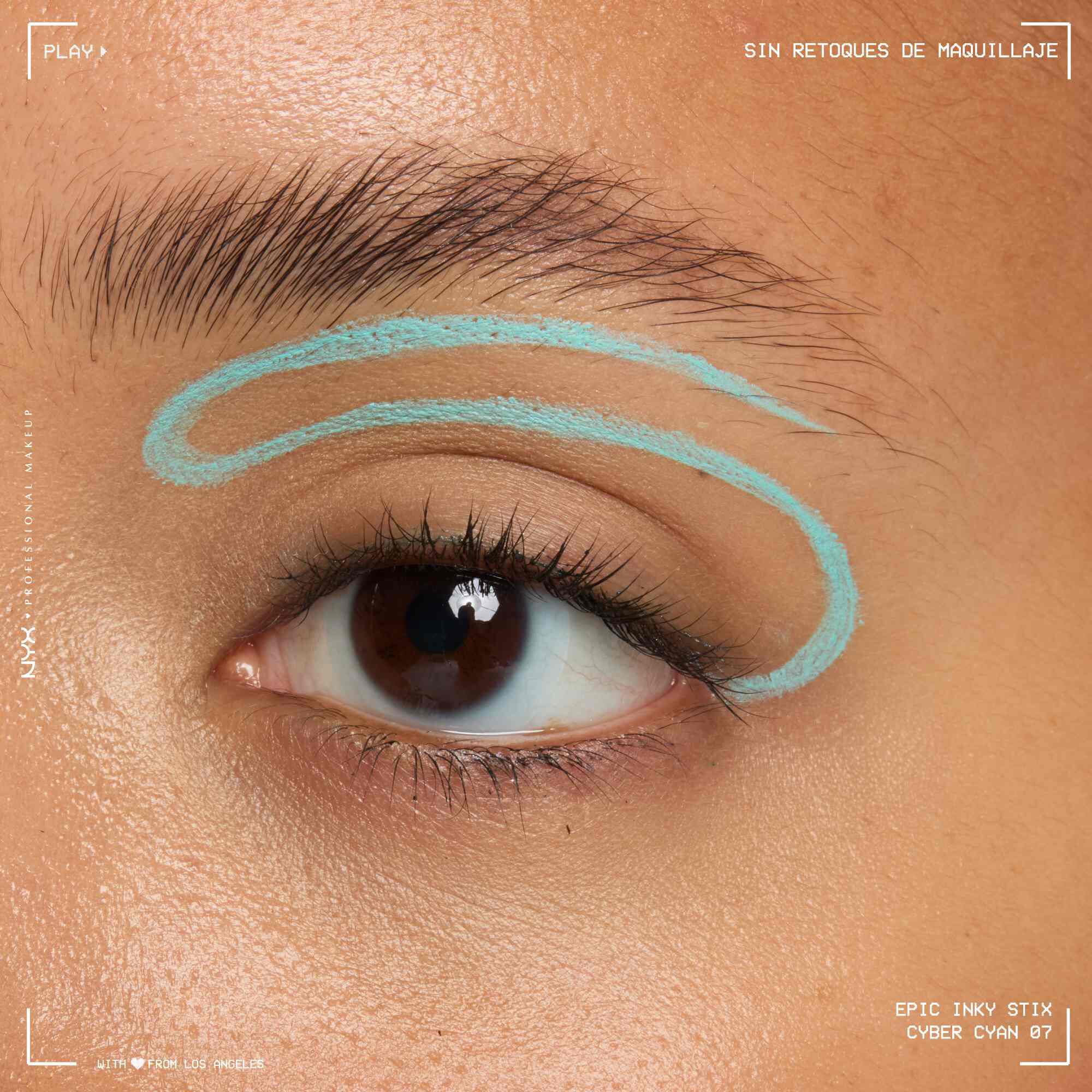 Close of a model wearing Epic Inky Stix on the top of their eyelid as a winged liner style in shade 06 Cyber Cyan