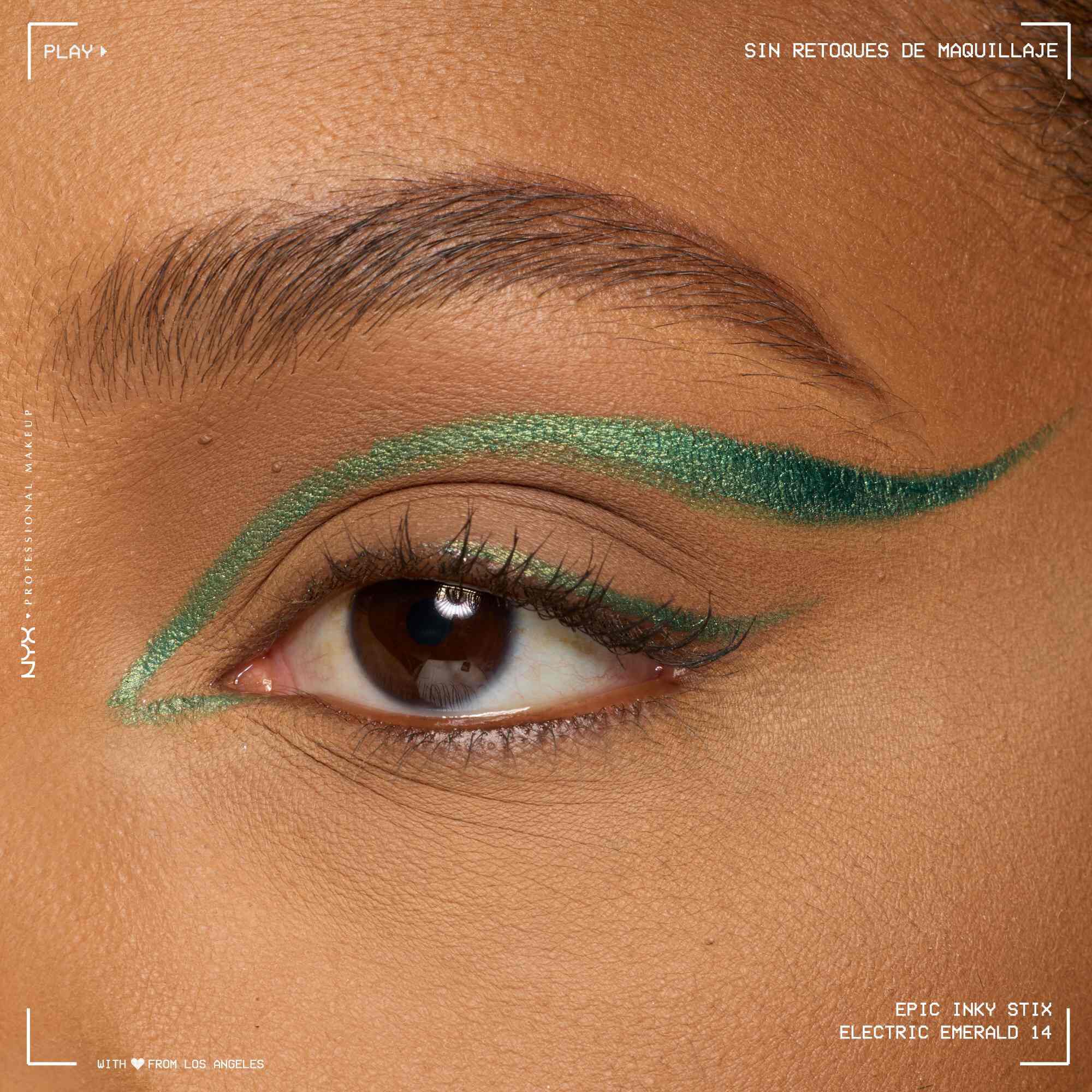 Close of a model wearing Epic Inky Stix on the top of their eyelid as a winged liner style in shade 14 Electric Emerald