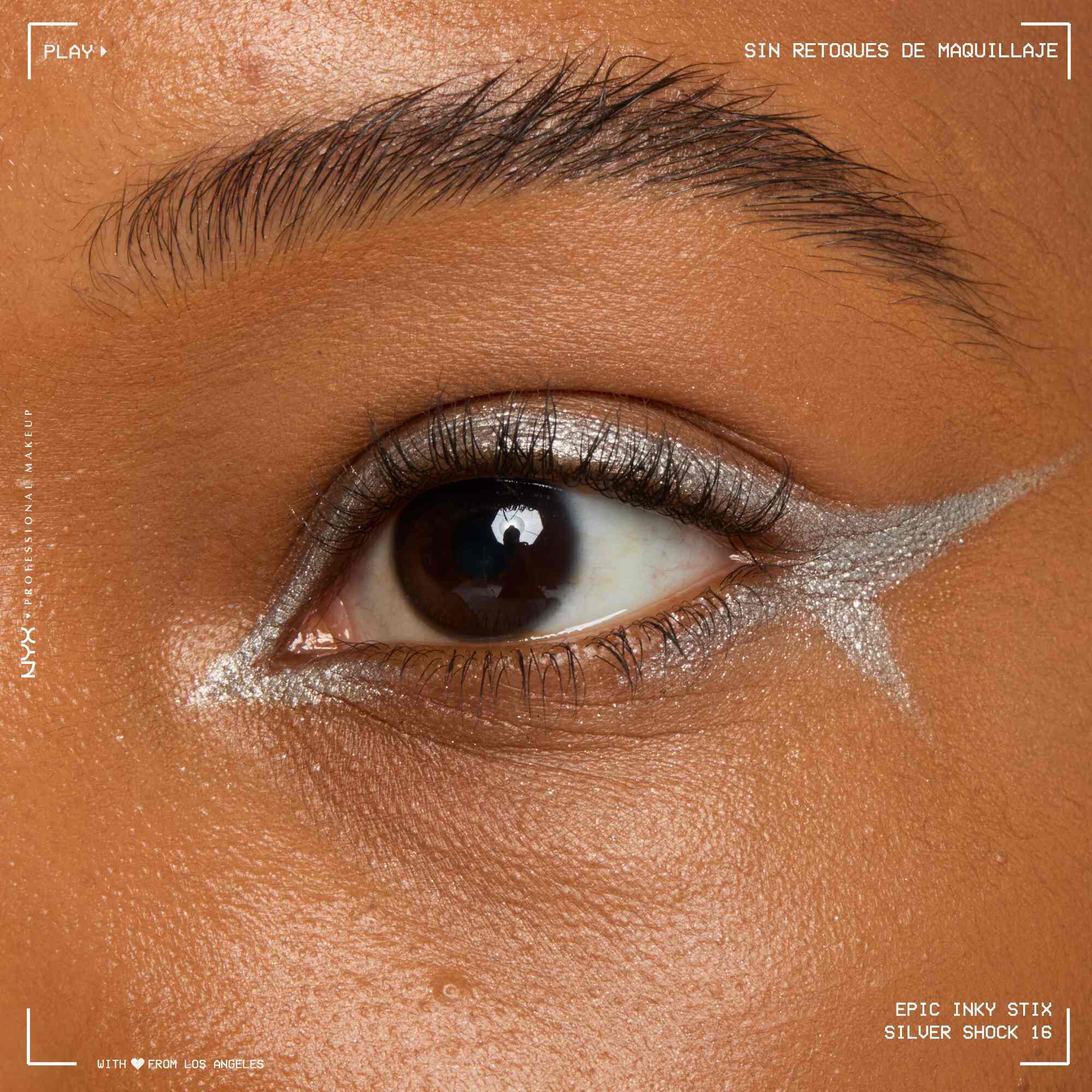 Close of a model wearing Epic Inky Stix on the top of their eyelid as a winged liner style in shade 16 Silver Shock